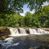 a large waterfall over a body of water