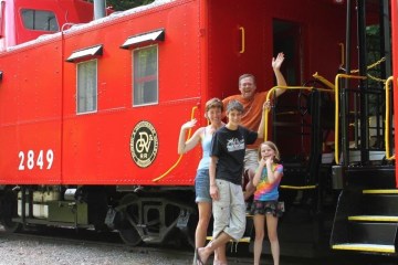 a person standing next to a train