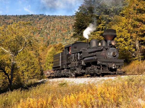 a train on a track with smoke coming out of it