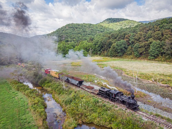 a train on a track with smoke coming out of it