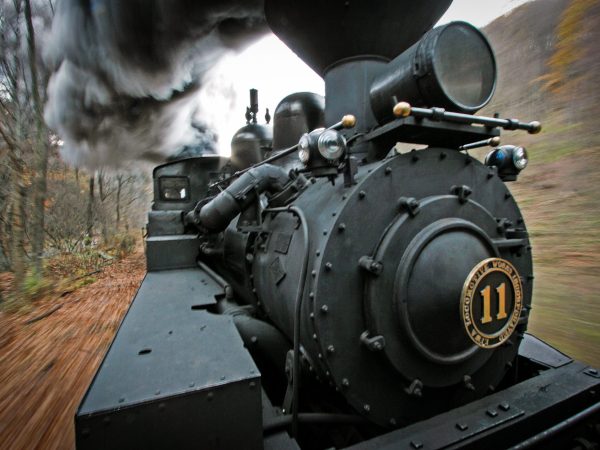 a train is parked on the side of the road
