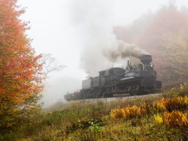 a train on a track with smoke coming out of it