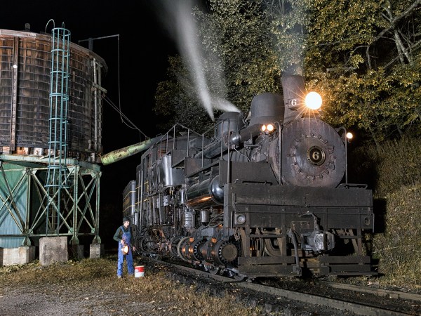 a train on a track with smoke coming out of it